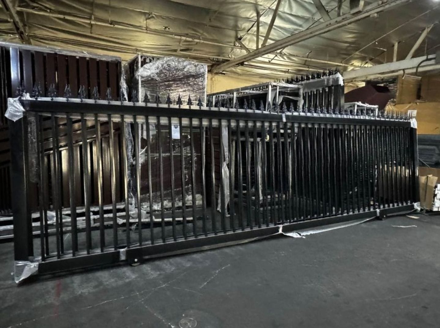 Black fence panel with spear-top finials before installation