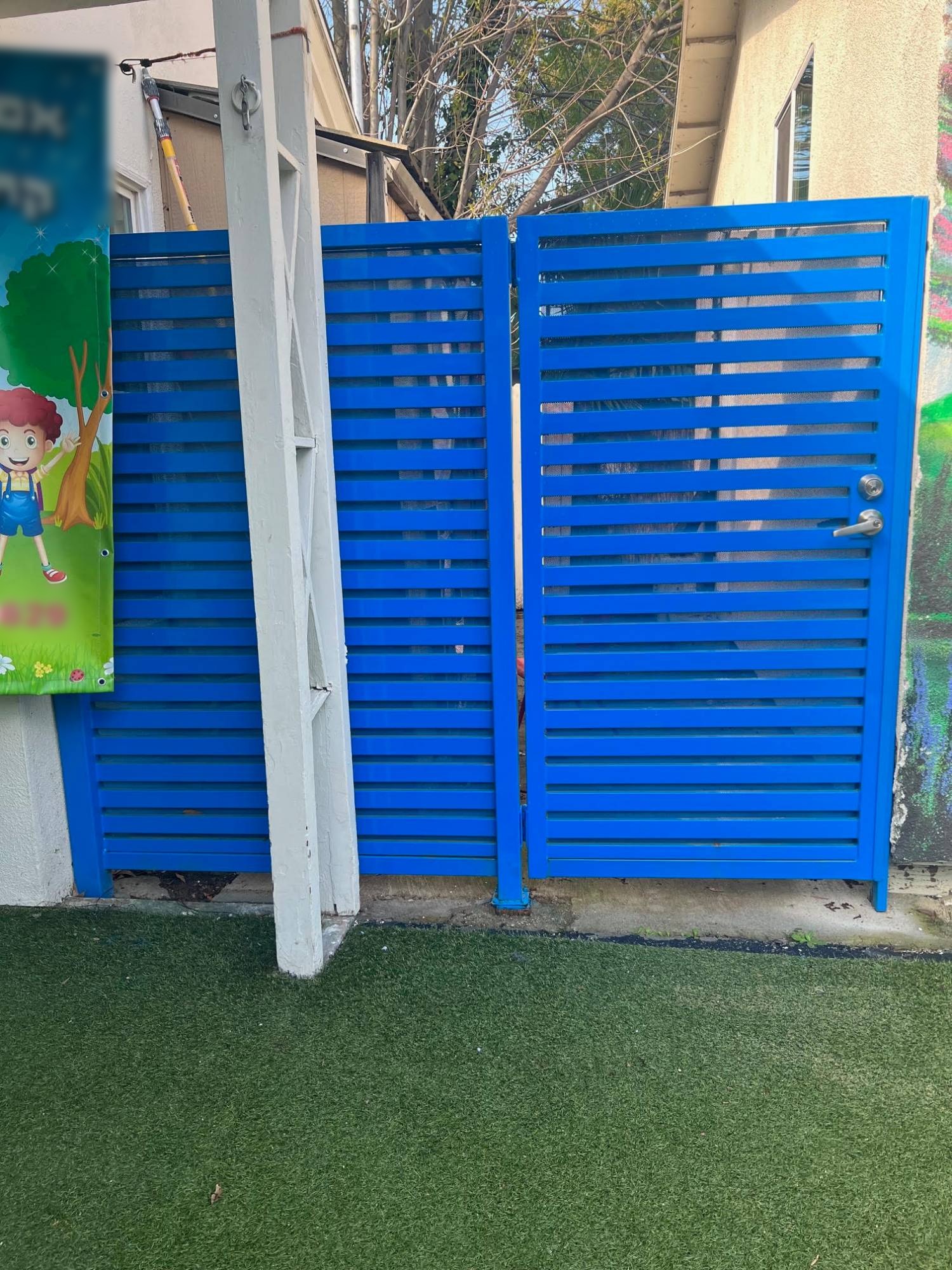 Blue horizontal slat walk-through gate with matching slat panel