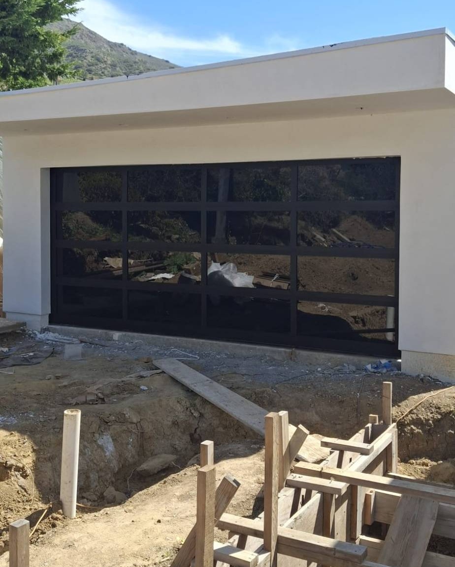 Dark glass garage door on a new home under construction